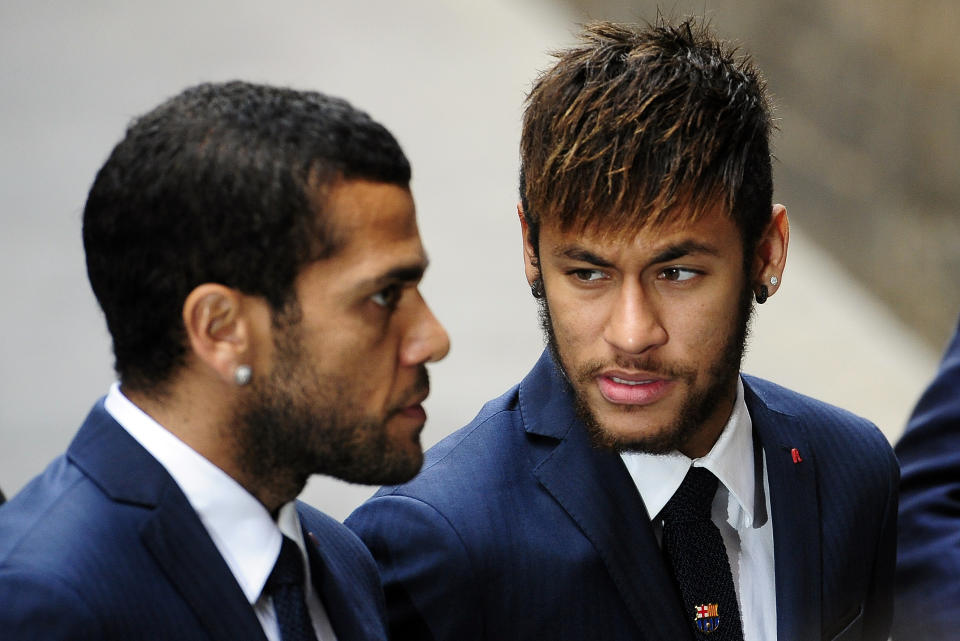 FC Barcelona's Neymar, from Brazil, right, and Daniel Alves, from Brazil, arrive for a religious ceremony at Barcelona Cathedral for late former FC Barcelona's coach Tito Vilanova in Barcelona, Spain, Monday, April 28, 2014. FC Barcelona announced on their web page Friday April 25, 2014, that Vilanova had died Friday following a long battle with throat cancer. He was 45. (AP Photo/Manu Fernandez)