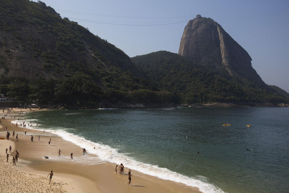 This Sept. 7, 2012 photo shows Praia Vermelha, or 'Red beach' at the foot of the Sugarloaf Mountain in Rio de Janeiro, Brazil. Rio boasts some of the world's most stunning urban beaches and they're worth several visits. Cariocas spend much of their free time sunning themselves, chatting up neighbors, toning their muscles and then showing them off on these long stretches of white sand, so beach-going makes for great people-watching. Go to Copacabana, Ipanema, Leblon or Praia Vermelha, at the foot of the Sugarloaf Mountain, if you want to stay in the city. (AP Photo/Felipe Dana)