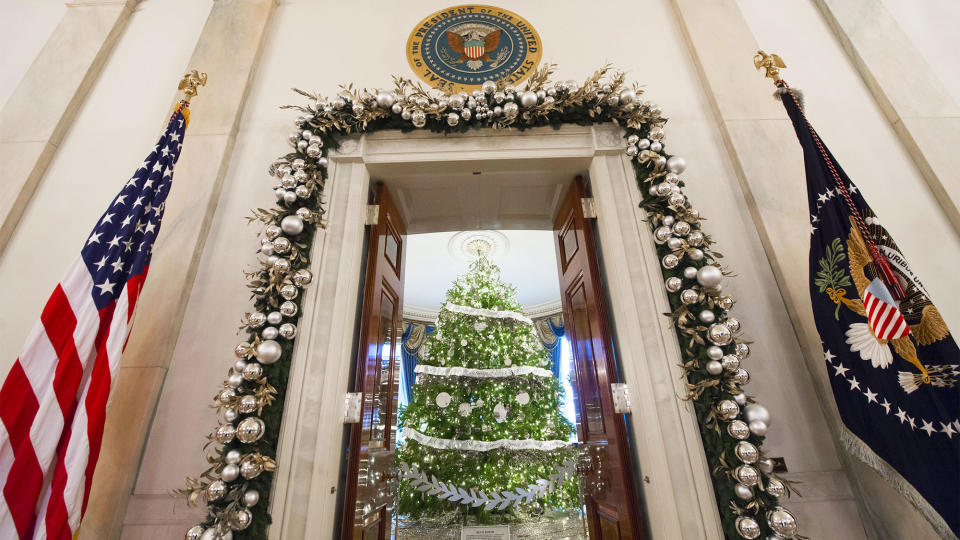 The White House Christmas Tree in the Blue Room and holiday decorations are seen from the Grand Foyer of the White House