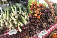 Leeks and beets are displayed at a farmer's market in Waitsfield, Vt., on Aug. 28, 2021. Signing up for a Community-Supported Agriculture program means getting a box of produce from local farms every week or two. It's a great way to take advantage of summer's bounty, discover new fruits and vegetables, and support the folks who grow food in your area. (AP Photo/Carolyn Lessard)