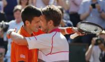 Stan Wawrinka of Switzerland (R) hugs Novak Djokovic of Serbia after winning their men's final match at the French Open tennis tournament at the Roland Garros stadium in Paris, France, June 7, 2015. REUTERS/Vincent Kessler