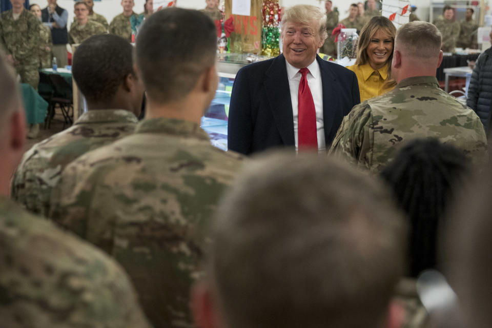 President Donald Trump and first lady Melania Trump visit with members of the military at a dining hall at Al Asad Air Base, Iraq, Wednesday, Dec. 26, 2018. (AP Photo/Andrew Harnik)