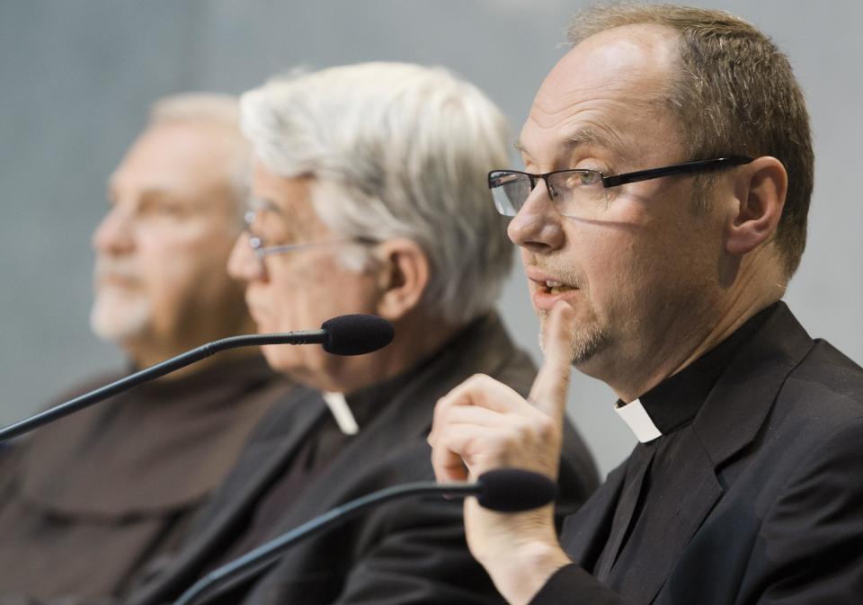 Monsignor Slawomir Oder, postulator of late Pope John Paul II, right, speaks during a press conference in Vatican City, Tuesday, April 22, 2014. Polish priest Oder, who has spearheaded the case to make Pope John Paul II a saint, says there is no documentation that he had any "personal involvement" in the scandal of the Legion of Christ religious order. John Paul and his closest advisers had held up the Legion and its late founder, the Rev. Marcial Maciel, as a model for the faithful, even though the Vatican for decades had documentation with credible allegations that Maciel was a pedophile and drug addict with a questionable spiritual life. (AP Photo/Domenico Stinellis)