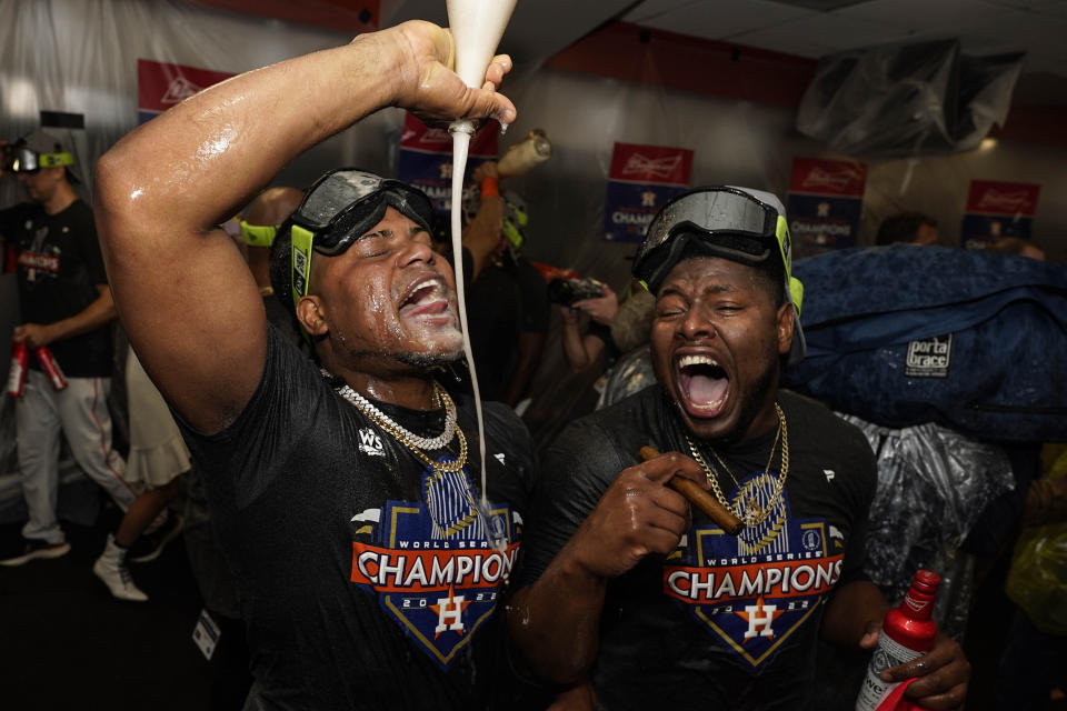 Houston Astros starting pitcher Framber Valdez, and Hector Neris celebrate in the locker room after their 4-1 World Series win against the Philadelphia Phillies in Game 6 on Saturday, Nov. 5, 2022, in Houston. (AP Photo/David J. Phillip)
