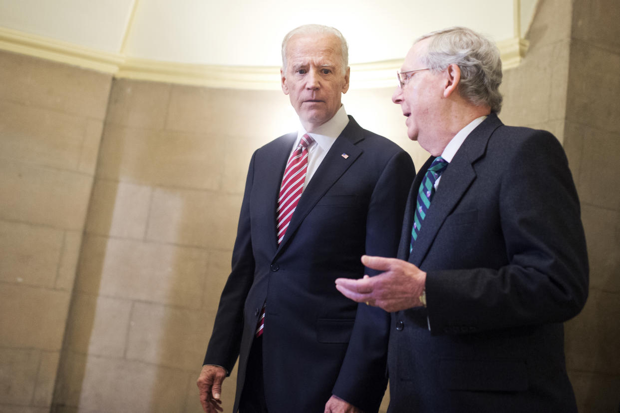 Then-Vice President Joe Biden and Then-Senate Majority Leader Mitch McConnell make their way to the House floor for President Obama's State of the Union address on January 12, 2016. (Photo By Tom Williams/CQ Roll Call)