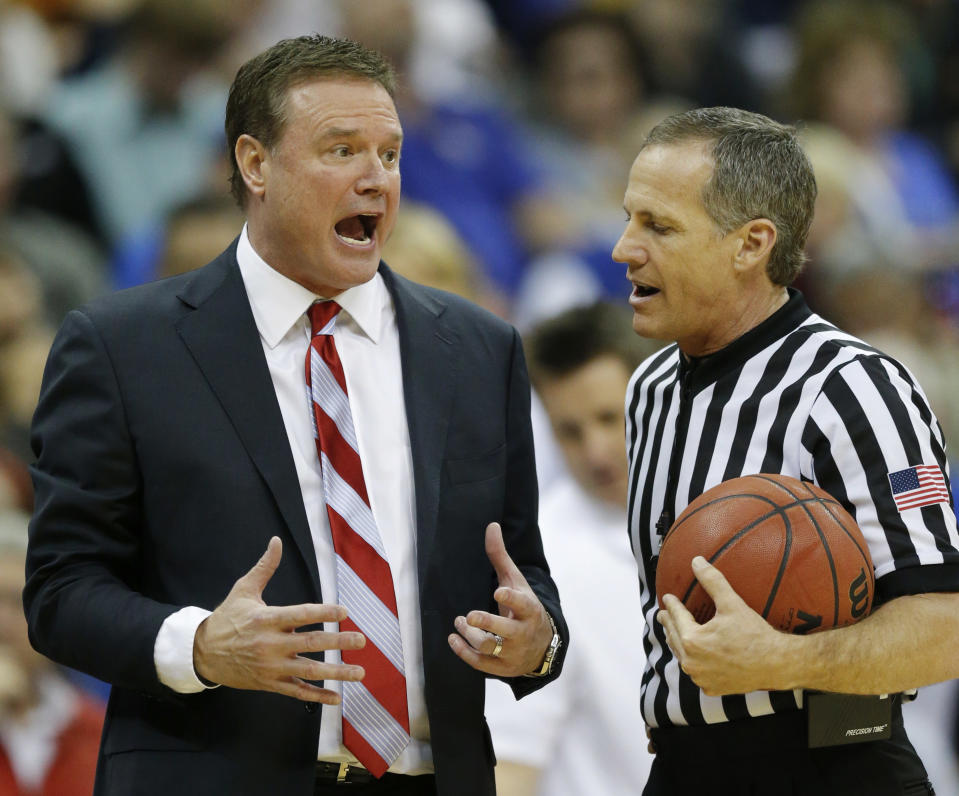 Kansas head coach Bill Self, left, talks with a referee during the second half of an NCAA college basketball game against Iowa State in the semifinals of the Big 12 Conference men's tournament in Kansas City, Mo., Friday, March 14, 2014. Iowa State defeated Kansas 94-83. (AP Photo/Orlin Wagner)