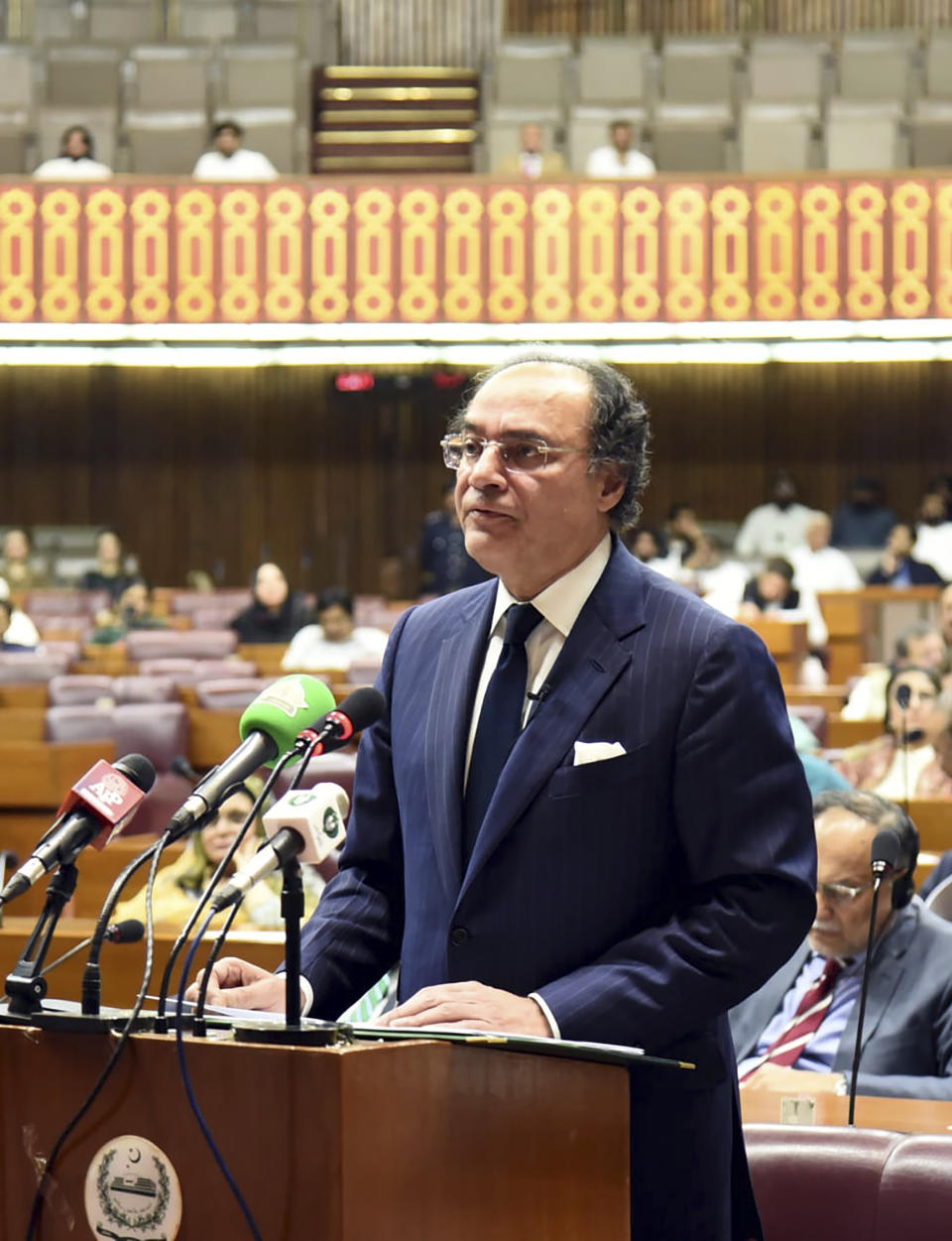 In this handout photo released by Pakistan finance Ministry Press Service, Pakistan's Finance Minister Muhammad Aurangzeb speaks and parented, the Federal Budget before the National Assembly of Pakistan, in Islamabad, Pakistan. Wednesday, June. 12, 2024. Pakistan's new gov't presents its first budget in Parliament as it seeks new long-term IMF bailout. (Pakistan Foreign Ministry Press Service via AP)