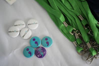 Pins free for students to take sit on a table as the Miami Arts Studio mental health club raises awareness on World Mental Health Day, Tuesday, Oct. 10, 2023, at the public 6th-12th grade magnet school in Miami. (AP Photo/Rebecca Blackwell)