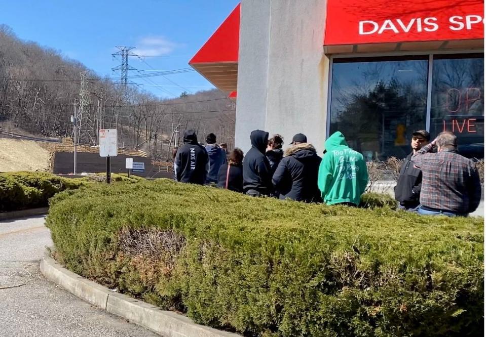 Shoppers await entry into outdoor gear, gun and ammunition retailer Davis Sport Shop in Sloatsburg, New York Saturday, March 21, 2020.