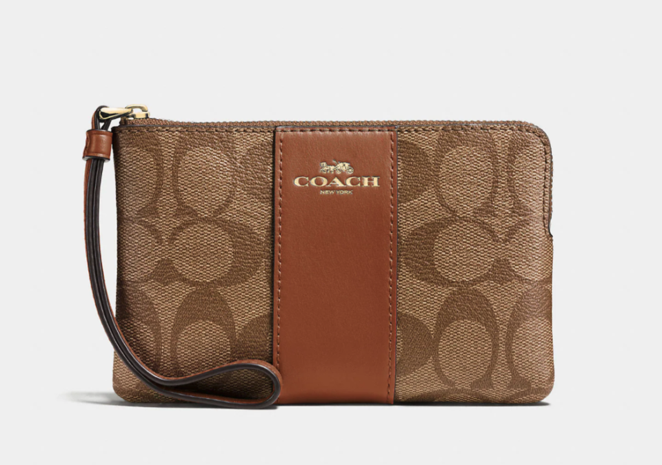 Corner Zip Wristlet In Signature Canvas. Image via Coach Outlet.