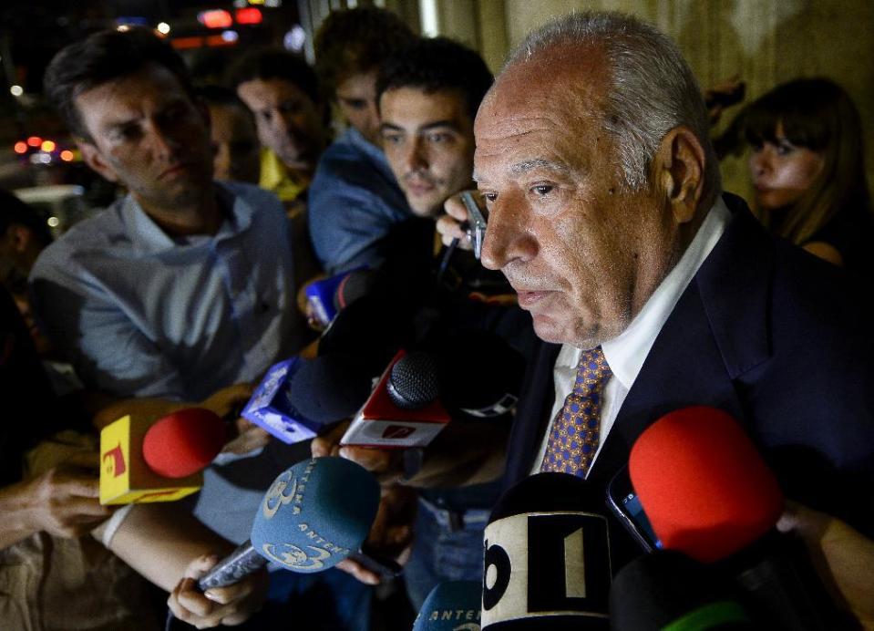 FILE - In this Tuesday, Aug. 5, 2014 file photo, Dan Voiculescu, a Romanian media mogul, speaks to the media after exiting the Appeal Court's building in Bucharest, Romania. Dan Voiculescu, the former owner of Antena, began a 10-year sentence for money laundering in 2014, at which point his daughters took over the television station. (Octav Ganea,/Mediafax via AP, file)