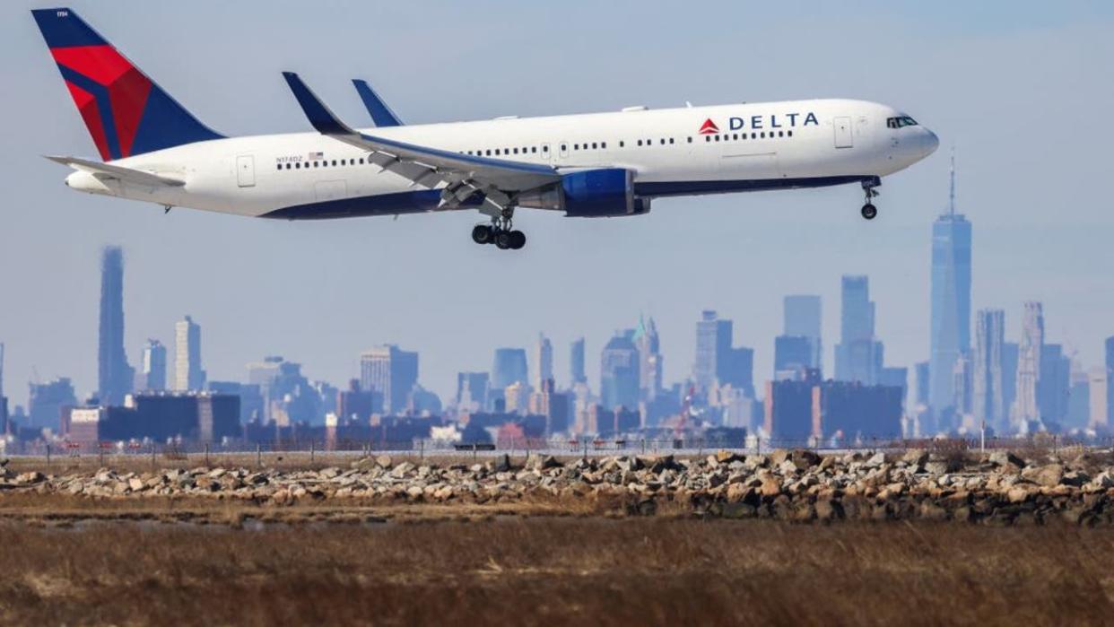 <div>A Boeing 767 passenger aircraft of Delta airlines arrives from Dublin at JFK International Airport in New York as the Manhattan skyline looms in the background on February 7, 2024. (Photo by Charly TRIBALLEAU / AFP) (Photo by CHARLY TRIBALLEAU/AFP via Getty Images)</div>