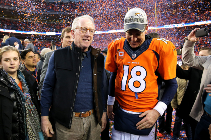 DENVER, CO - JANUARY 24: Peyton Manning #18 of the Denver Broncos and father Archie Manning walk off the field.