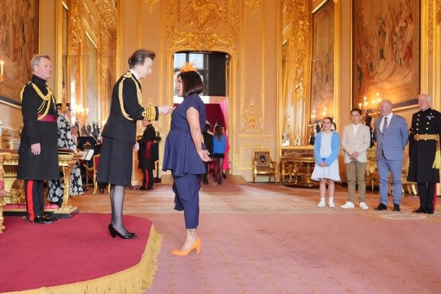 Camilla Bowry is made an Officer of the Order of the British Empire by the Princess Royal at Windsor Castle, Berkshire 