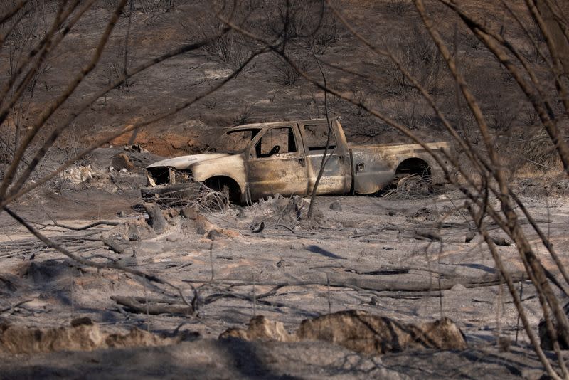 A burned truck is shown after the Bond Fire wildfire burned through portions of Modjeska Canyon, California