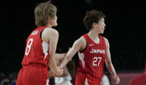 Japan's Saki Hayashi (27) celebrates with teammate Maki Takada (8) after making a three point basket during women's basketball preliminary round game against Nigeria at the 2020 Summer Olympics, Monday, Aug. 2, 2021, in Saitama, Japan. (AP Photo/Eric Gay)