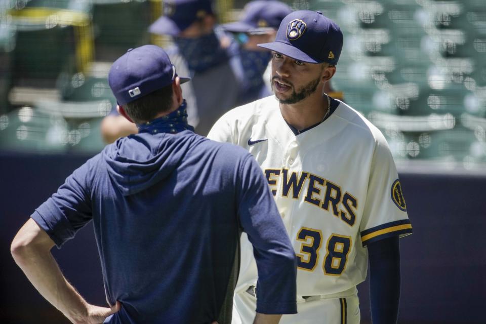 Milwaukee Brewers' Devin Williams talks to manager Craig Counsell during a practice session Monday, July 13, 2020, at Miller Park in Milwaukee. (AP Photo/Morry Gash)