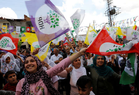 People wave flags as they attend a campaign event by Turkey's main pro-Kurdish Peoples' Democratic Party (HDP) in Silvan, a town in Diyarbakir province, Turkey, June 5, 2018. Picture taken June 5, 2018. REUTERS/Umit Bektas