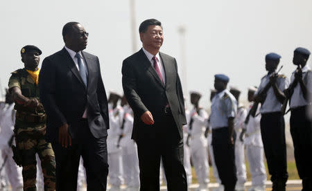 Chinese President Xi Jinping walks with Senegal's President Macky Sall after arriving at the Leopold Sedar Senghor International Airport, at the start of his visit to Dakar, Senegal July 21, 2018. REUTERS/Mikal McAllister