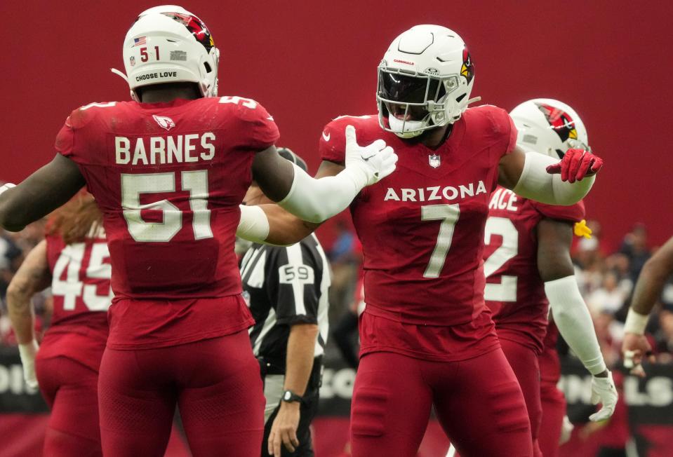 Arizona Cardinals linebackers Kyzir White (7) and Krys Barnes (51) celebrate their defensive stop against the Dallas Cowboys at State Farm Stadium in Glendale on Set. 24, 2023.