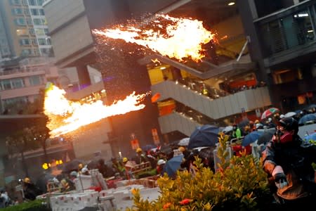 FILE PHOTO: An anti-extradition bill protester throws a Molotov cocktail as protesters clash with riot police during a rally to demand democracy and political reforms, at Tsuen Wan, in Hong Kong