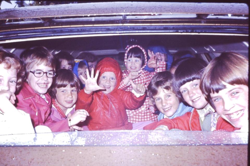 Heidi sits center, in the red hooded coat. Her little sister is next to her, wearing the gingham coat. Her older sister is second from the far right. (Photo: Courtesy of Heidi Legg)