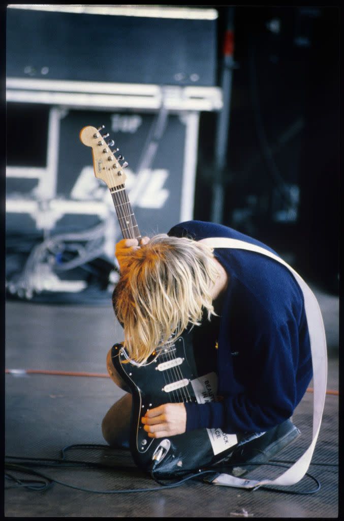 <p>Another shot of Cobain at the Pukkelpop Festival in Hasselt, Belgium in 1991. The artist was known for his unique antics on stage, which defined grunge as a genre for years to come. </p>