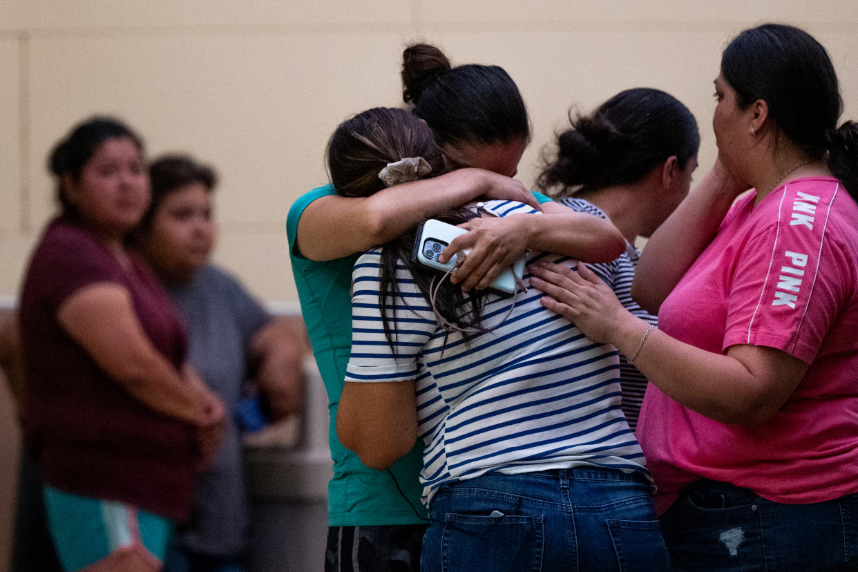 People grieve outside the civic center in Uvalde, Texas