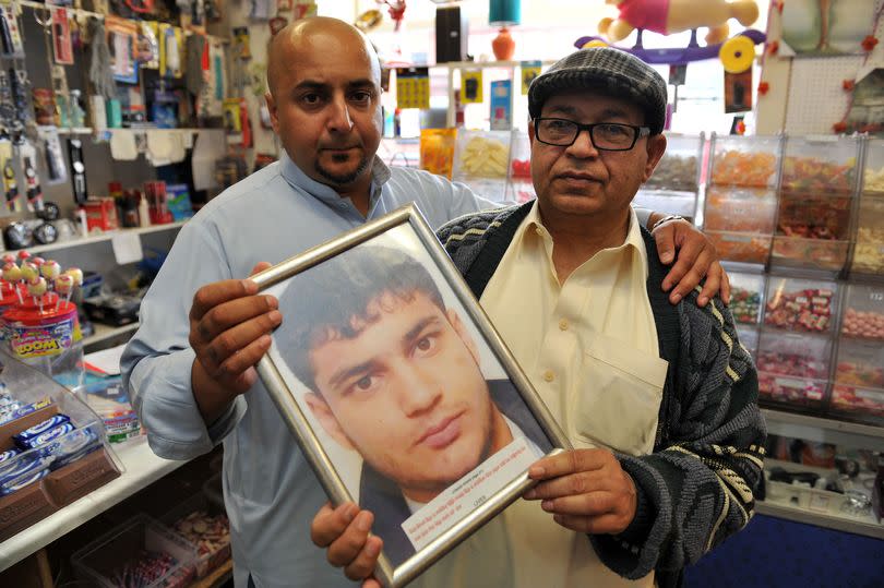Mumtaz Khan, right, holds a picture of his son, Junaid Khan, alongside Junaid's brother, Mohd Imitaz Khan, left -Credit:MEN Media