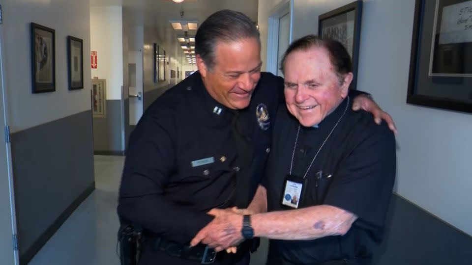 Los Angeles Police Capt. Aaron Ponce, left, shakes hands with Monsignor Frank Hicks of the LAPD Chaplain Corps. - CNN