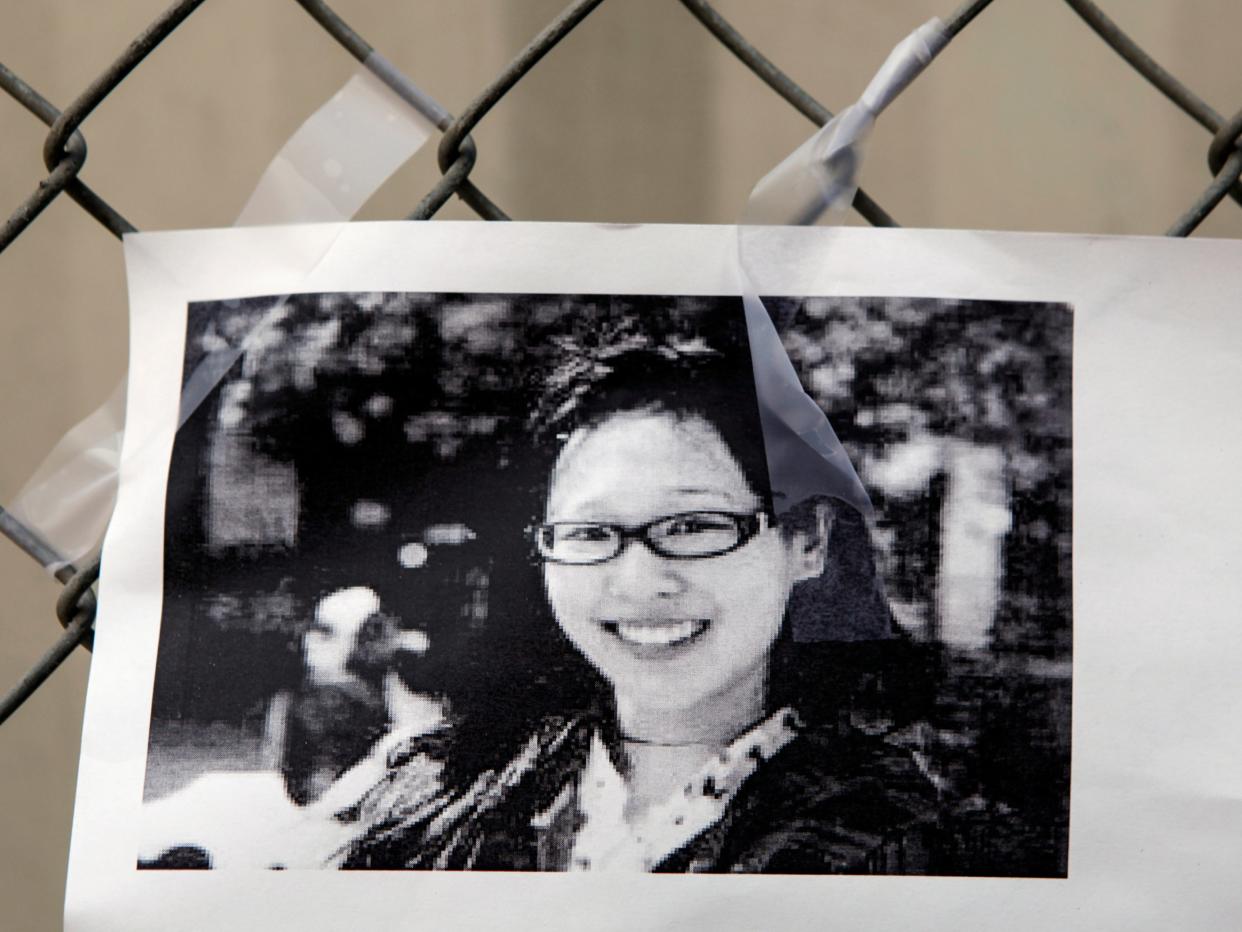 A photocopy showing a photo of Elisa Lam is displayed at a street memorial across the Cecil Hotel in Los Angeles on 21 February 2013 (AP Photo/Damian Dovarganes)