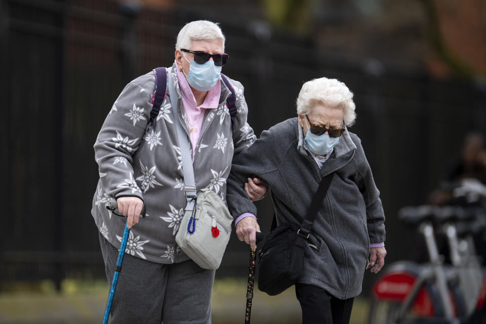 LONDON, UNITED KINGDOM - APRIL 01: Elderly members of the public wearing face masks walk down a street in Central London on April 01, 2020 in London, England. The Coronavirus (COVID-19) pandemic has spread to many countries across the world, claiming over 40,000 lives and infecting hundreds of thousands more. (Photo by Justin Setterfield/Getty Images)