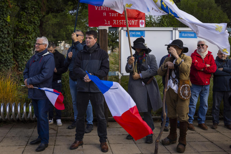 People gather in Saint-Jean-de-Monts, western France on Saturday Nov. 4, 2023, at the call of a far-right group against the reception in the town of 15 migrants. (AP Photo/Jeremias Gonzalez)