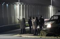 French police forces take position during clashes with migrants at the "Jungle" migrant camp in Calais, northern France, on October 23, 2016