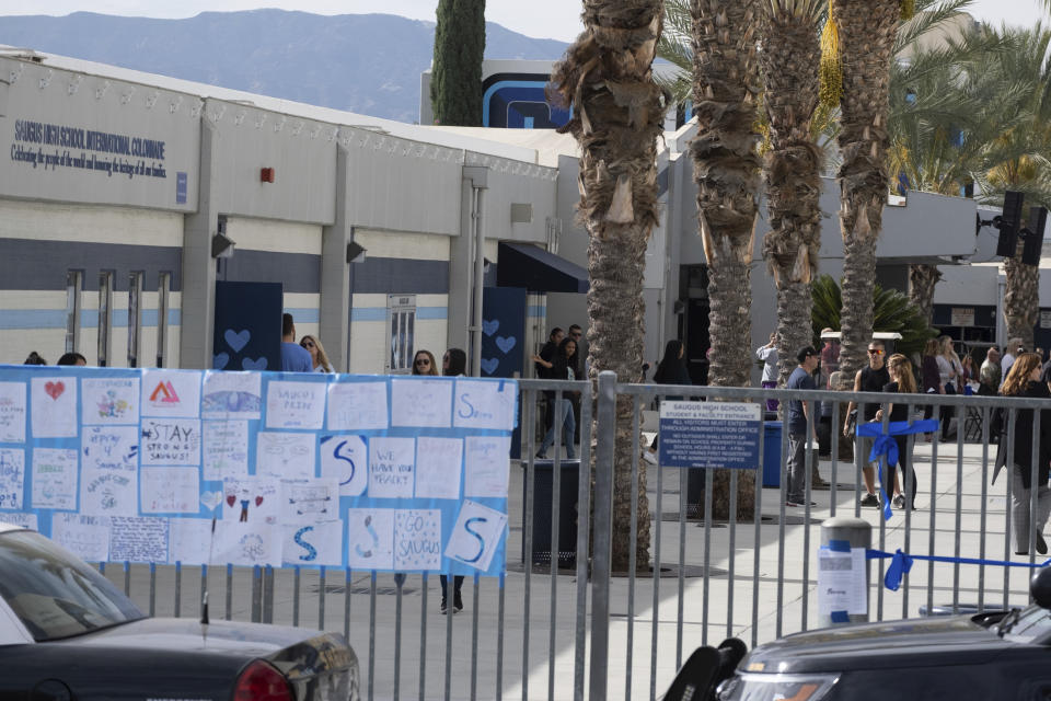 Students on campus near the quad area at Saugus high Tuesday, Nov. 19, 2019. Students were allowed back to collect their belongings left behind after the tragic shooting last Thursday. Classes will resume at the high school on Dec. 2. (David Crane/The Orange County Register via AP)