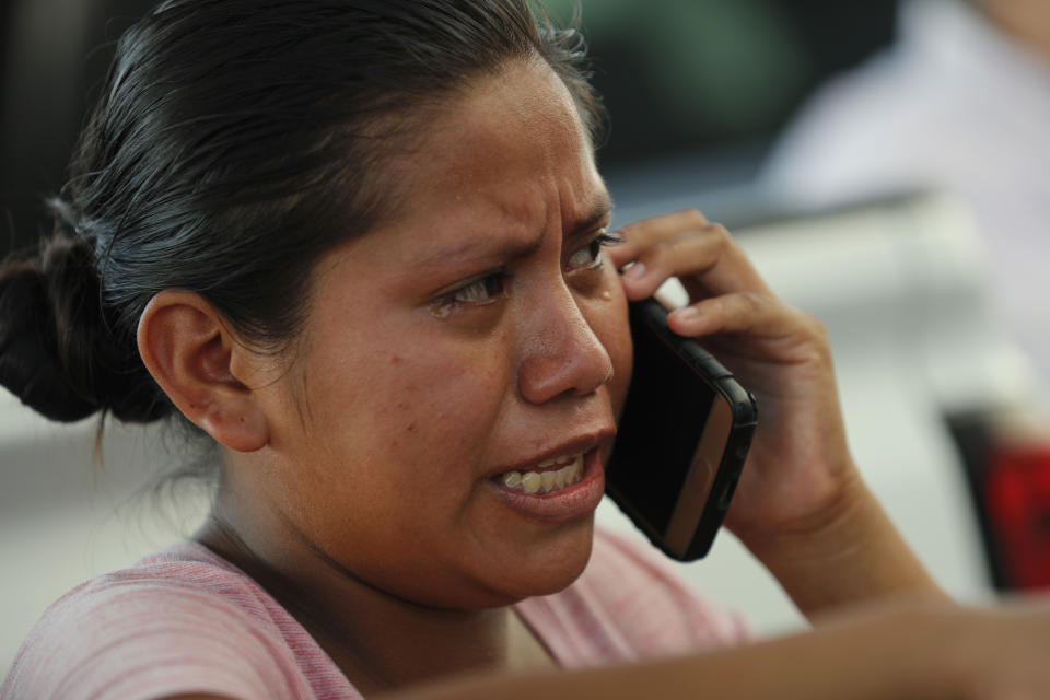 A migrant cries as she speaks on the phone, at an immigration center on the International Bridge 1, in Nuevo Laredo, Mexico, Tuesday, July 16, 2019. A U.S. policy to make asylum seekers wait in Mexico while their cases wind through clogged U.S. immigration courts has also expanded to the violent city of Nuevo Laredo. (AP Photo/Marco Ugarte)