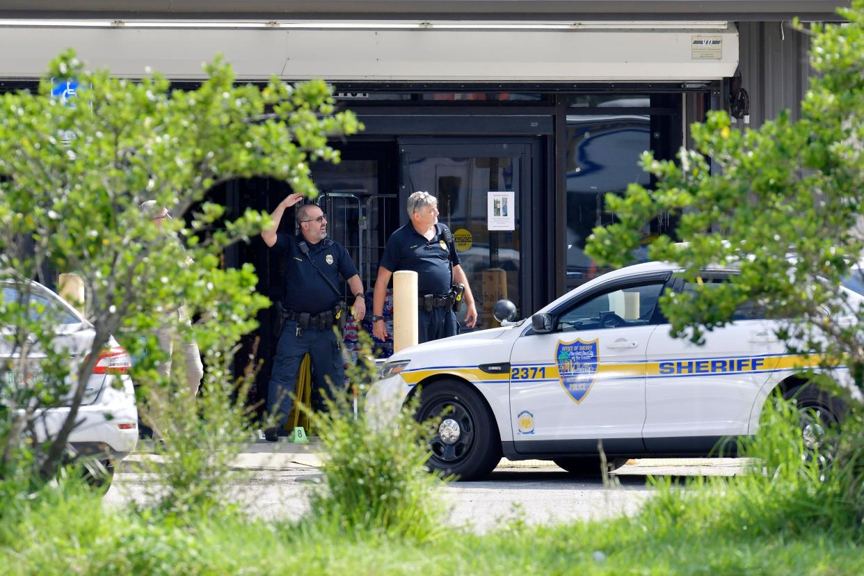 Investigators continued to gather evidence at the Dollar General store on Kings Road in Jacksonville one day after Saturday's racially motivated multiple shooting. 