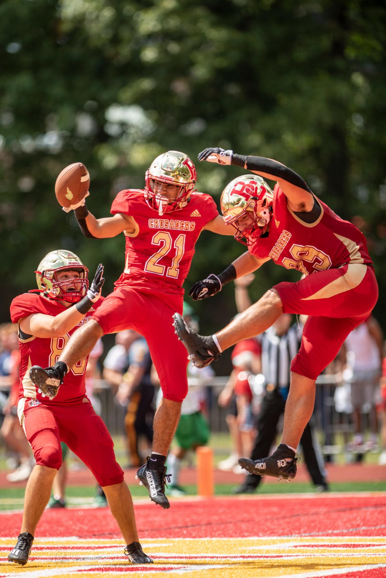 Bergen Catholic High School hosts Cardinal Gibbons in a football game on Saturday August 27, 2022. BC #21 Anthony Perrotti (center) and teammates celebrate a Perrotti’s touchdown. 