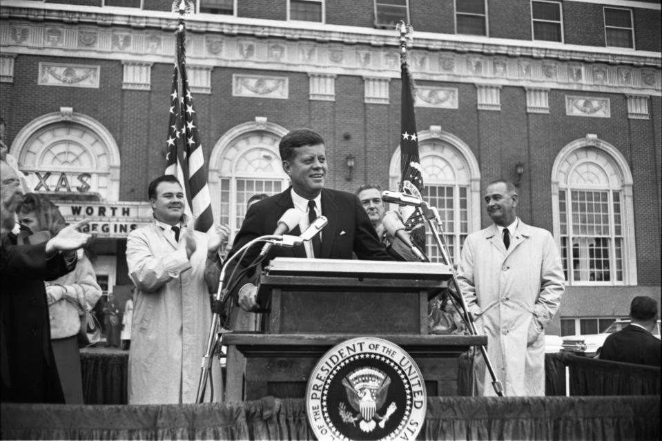 In this Nov. 22, 1963 photo provided by the The Sixth Floor Museum at Dealey Plaza, John F. Kennedy speaks outside the Hotel Texas in Fort Worth, Texas. An exhibit opening next year at the Dallas Museum of Art will feature almost all of the works of art gathered from museums and prominent Fort Worth citizens for the hotel suite Kennedy and first lady Jacqueline Kennedy stayed in the night before he was assassinated. (AP Photo/The Sixth Floor Museum at Dealey Plaza)