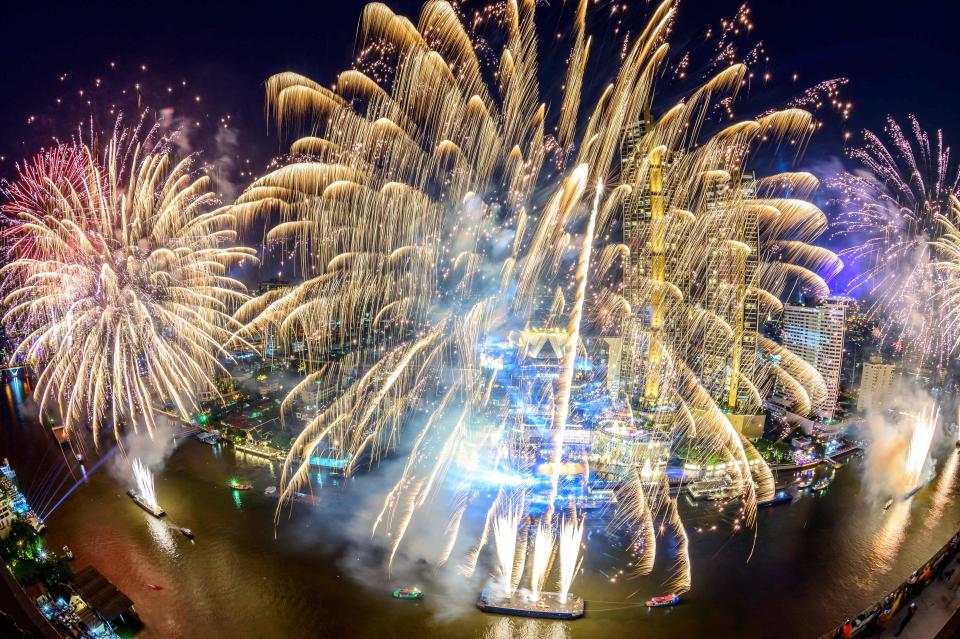 New Year's Eve fireworks erupt over Chao Phraya river during the fireworks show for New Year's Eve in BangkokAFP via Getty Images