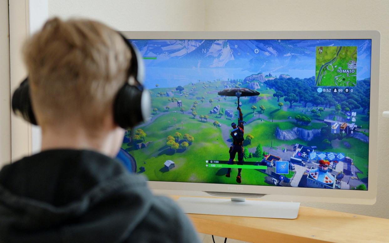 Teenager playing the online game Fortnite - Alamy Pay