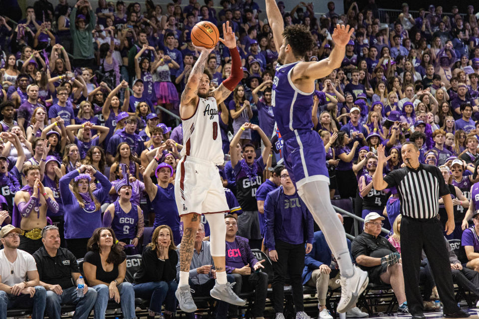 Teddy Allen (0) shoots for three as the New Mexico State Aggies face off against the Grand Canyon Lopes at GCU Arena in Phoenix on Saturday, Feb. 19, 2022.