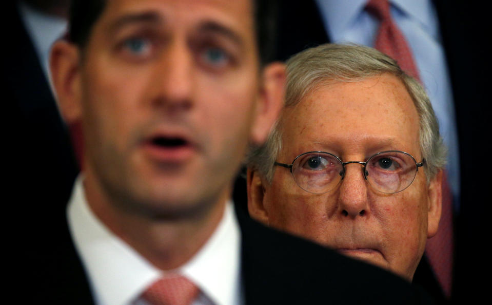 U.S. Senate Majority Leader Mitch McConnell (R) listens to Speaker of the House Paul Ryan (L) speak about the Republican tax plan in the U.S. Capitol in Washington, U.S., September 27, 2017. REUTERS/Kevin Lamarque