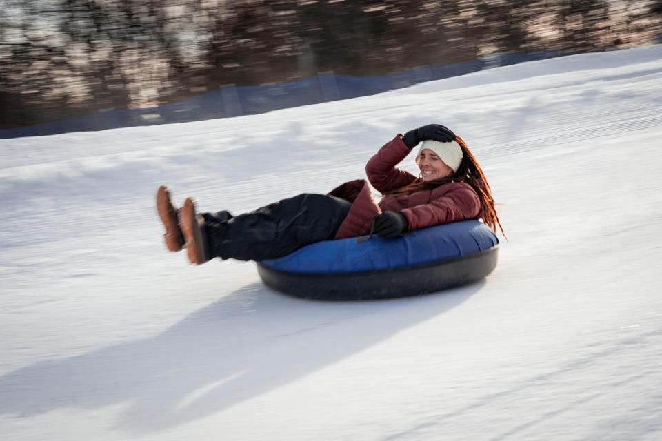 A snow tuber holds on tight as she speeds down a hill at Seven Oaks recreation area in Boone, Iowa.