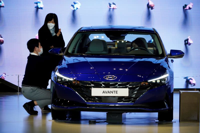 FILE PHOTO: Women wearing masks to prevent contracting the coronavirus disease (COVID-19) take a look at a Hyundai Motor vehicle at Hyundai Motor Studio in Goyang