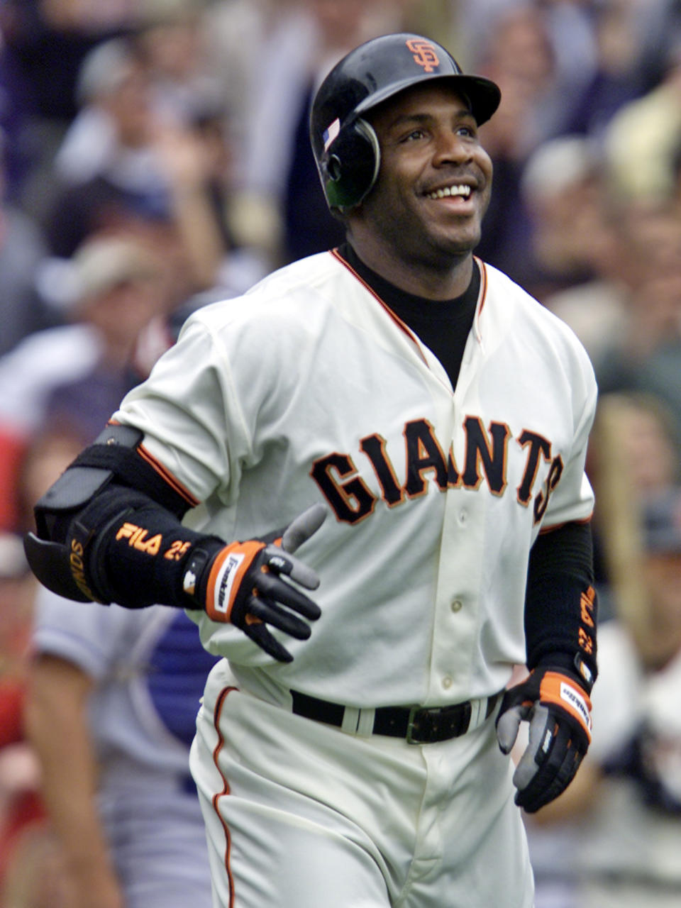 FILE - In this Oct. 7, 2001, file photo, San Francisco Giants' Barry Bonds smiles as he begins to round the bases after he hit his 73rd home run of the season, against the Los Angeles Dodgers in a baseball game in San Francisco. The baseball Hall of Fame won’t have any new players in the class of 2021 after voters decided no one had the merits — on-the-field or off — for enshrinement in Cooperstown on this year's ballot. Curt Schilling, Bonds and Roger Clemens were the closest in voting by members of the Baseball Writers' Association of America released Tuesday, and the trio will have one more chance at election next year. It's the first time the BBWAA didn't choose anyone since 2013. (AP Photo/Eric Risberg, File)