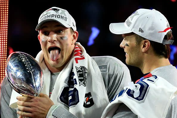 GLENDALE, AZ - FEBRUARY 01:  Rob Gronkowski #87 (L) and Tom Brady #12 of the New England Patriots celebrate while holding up the Vince Lombardi Trophy after defeating the Seattle Seahawks during Super Bowl XLIX at University of Phoenix Stadium on February 1, 2015 in Glendale, Arizona. The Patriots defeated the Seahawks 28-24.  (Photo by Rob Carr/Getty Images)