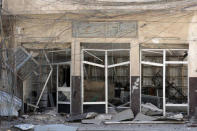 Wires hang in front of a destroyed shop in western Mosul, Iraq, April 6, 2017. REUTERS/Andres Martinez Casares