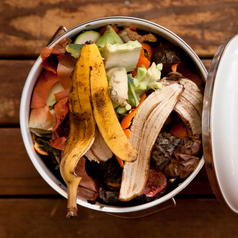 Compost bin full of vegetable peelings and banana peel