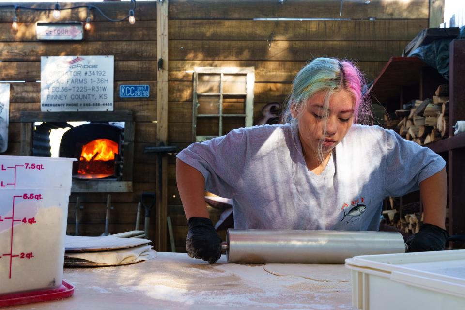 Emmey Birt rolls pizza dough at Blue Rooster Produce on Nov. 19, 2022 in Peoria, AZ.